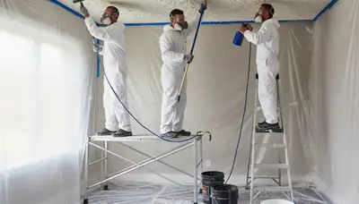 Technician removing popcorn ceiling in Clearwater FL home during expert ceiling refinishing service